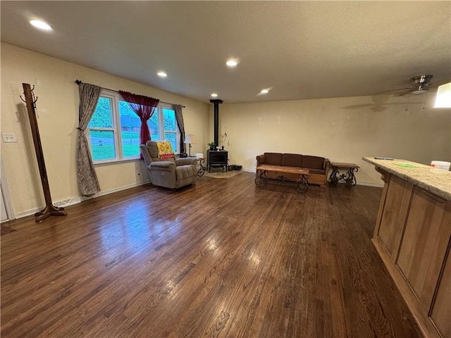 1403 E Mechanic St, Harrisonville, MO 64701 - living area with recessed lighting, ceiling fan, a wood stove, and dark wood finished floors