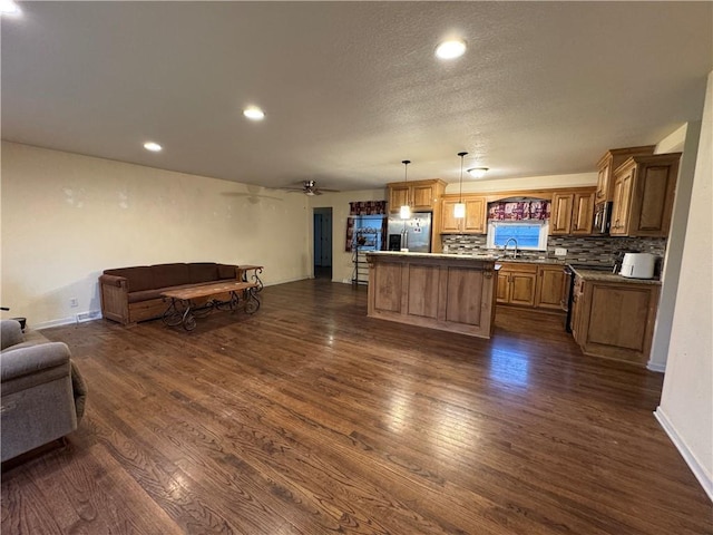 1403 E Mechanic St, Harrisonville, MO 64701 - kitchen with a sink, stainless steel appliances, open floor plan, dark wood-type flooring, and backsplash