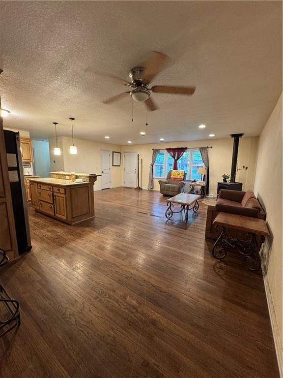 1403 E Mechanic St, Harrisonville, MO 64701 - living area featuring dark wood-type flooring, a ceiling fan, a textured ceiling, and recessed lighting