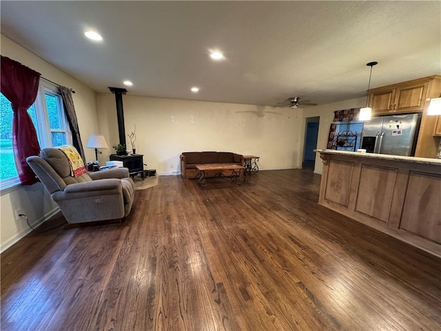 1403 E Mechanic St, Harrisonville, MO 64701 - living room with recessed lighting, a wood stove, a ceiling fan, and dark wood-style floors
