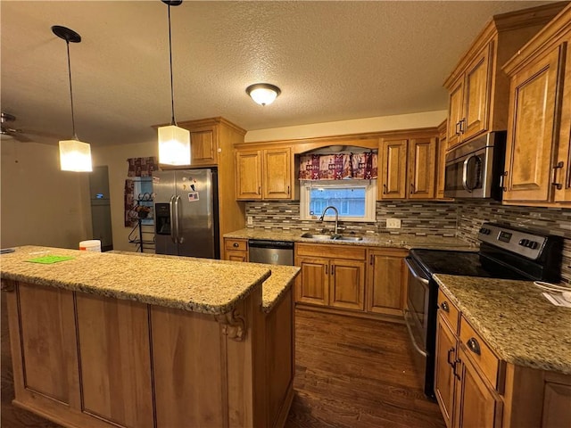 1403 E Mechanic St, Harrisonville, MO 64701 - kitchen featuring brown cabinets, appliances with stainless steel finishes, a kitchen island, and a sink