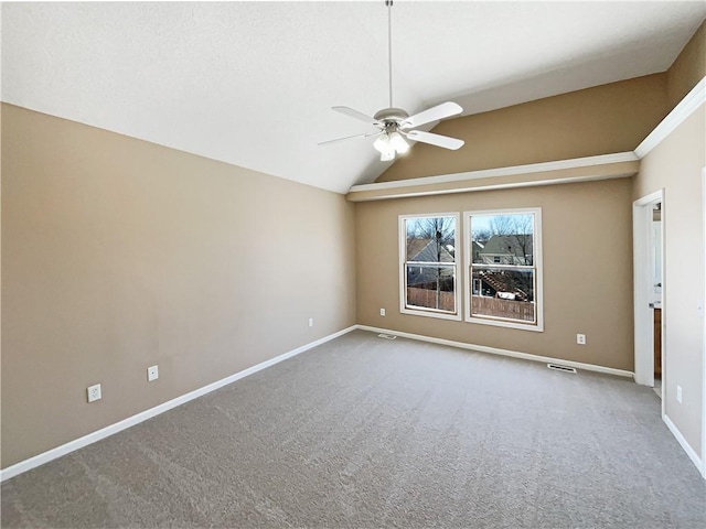 unfurnished room with visible vents, vaulted ceiling, a ceiling fan, and baseboards