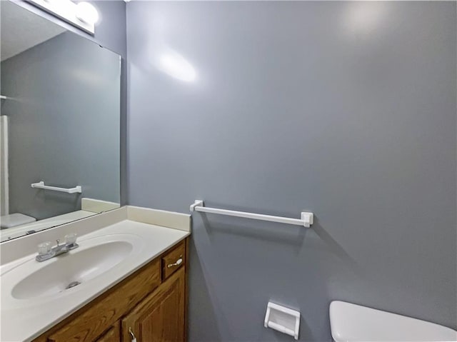 half bathroom with toilet and vanity