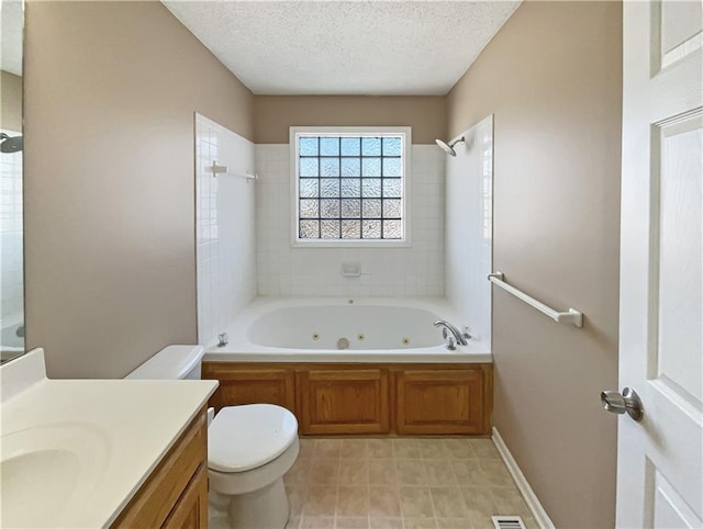 bathroom with baseboards, toilet, a combined bath / shower with jetted tub, a textured ceiling, and vanity