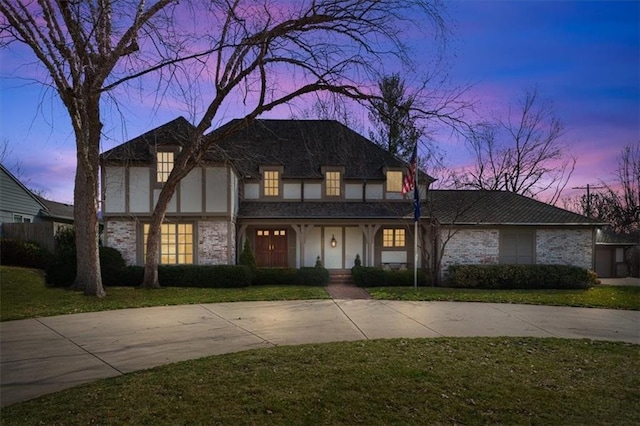 tudor house featuring a front yard