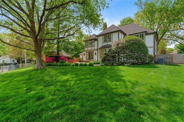 view of yard with central AC unit and fence