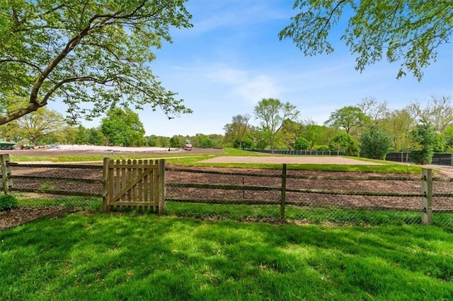 view of yard with a rural view and fence