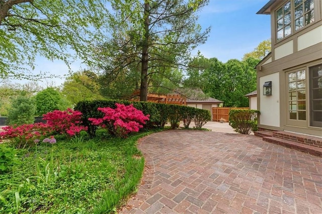view of yard with fence and a patio area