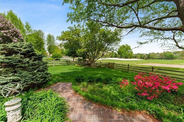 view of yard featuring a rural view and fence