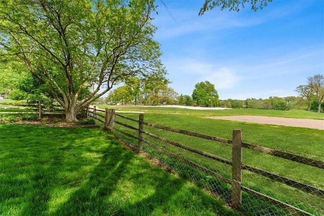 view of yard with a rural view and fence