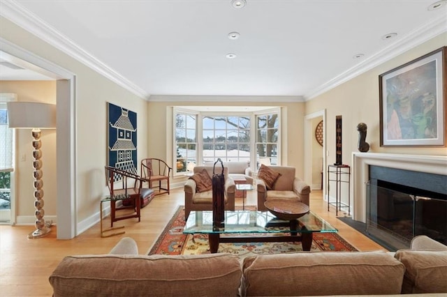living room featuring light wood-style floors, baseboards, and ornamental molding
