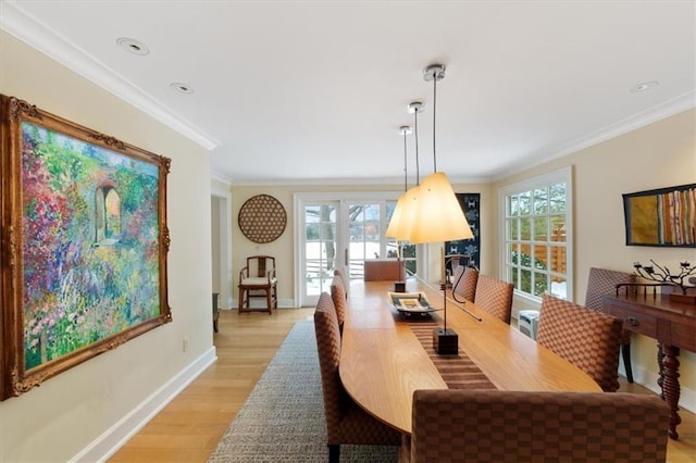 dining room with light wood-style floors, recessed lighting, baseboards, and crown molding