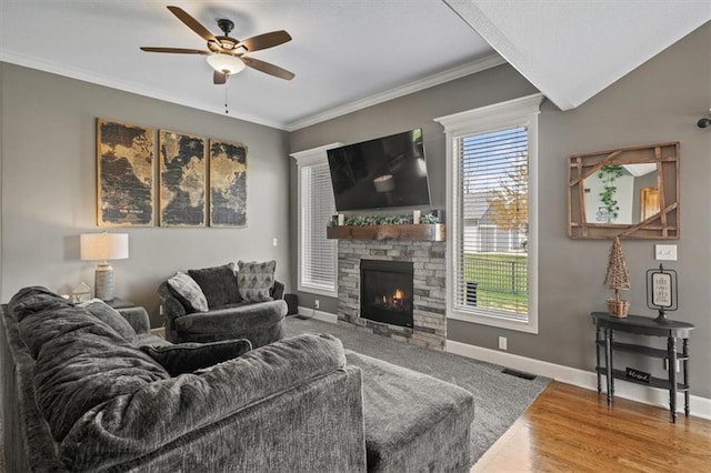 20880 W 224th St, Spring Hill, KS 66083 - living area featuring a ceiling fan, a stone fireplace, wood finished floors, baseboards, and crown molding