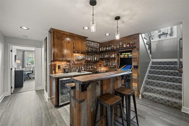 20880 W 224th St, Spring Hill, KS 66083 - indoor wet bar featuring beverage cooler, baseboards, stairs, light wood finished floors, and recessed lighting