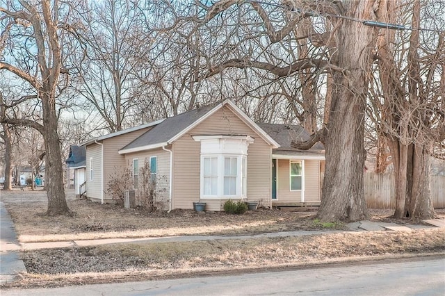 view of front of home with fence and central air condition unit