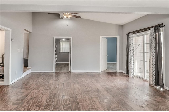 empty room with ceiling fan, baseboards, vaulted ceiling, and wood finished floors