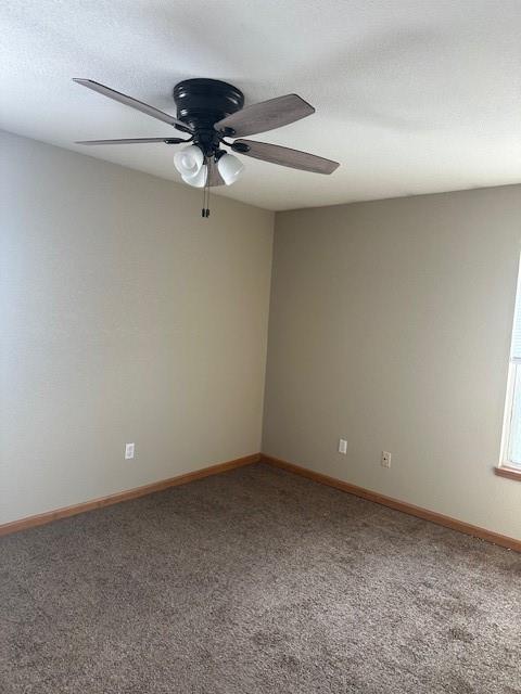 carpeted spare room with a ceiling fan, a textured ceiling, and baseboards