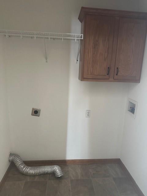 washroom featuring baseboards, washer hookup, cabinet space, and hookup for an electric dryer