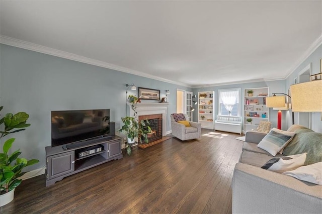 living area featuring crown molding, a fireplace, and wood finished floors