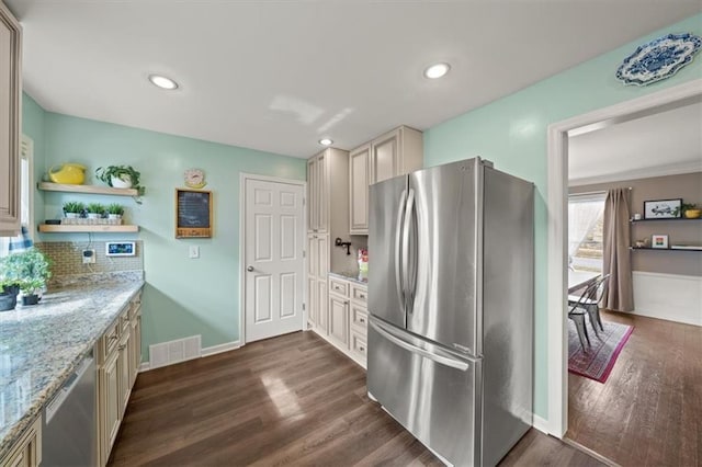 kitchen featuring dark wood finished floors, open shelves, stainless steel appliances, visible vents, and light stone countertops