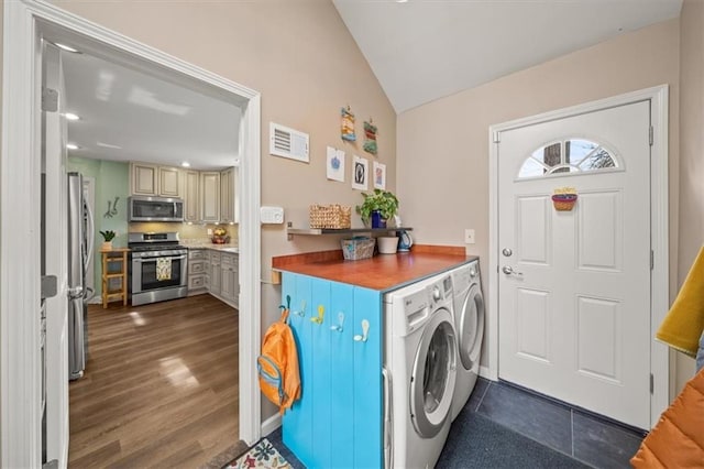 laundry area featuring laundry area, visible vents, washer and clothes dryer, and dark wood-type flooring