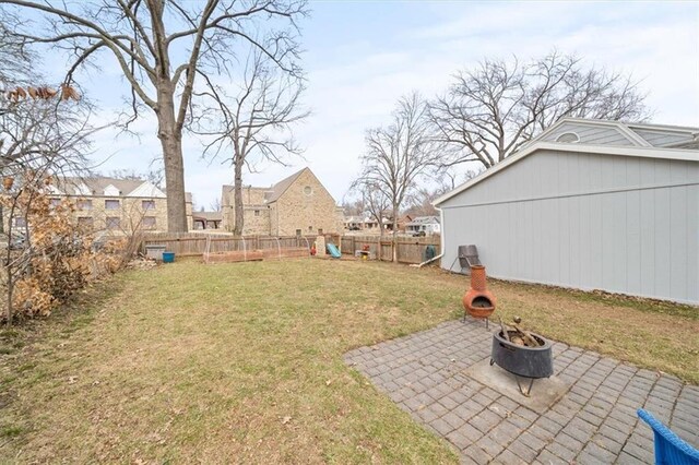 view of yard with a patio, an outdoor fire pit, and a fenced backyard