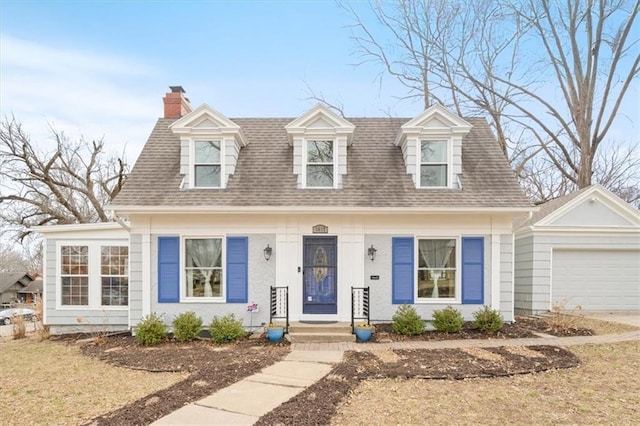 view of front of property with an attached garage, a shingled roof, and a chimney