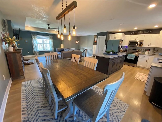 dining room featuring light wood-style floors, baseboards, a ceiling fan, and recessed lighting