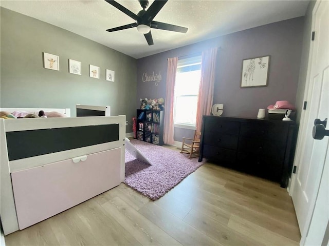 bedroom featuring light wood-style floors and ceiling fan