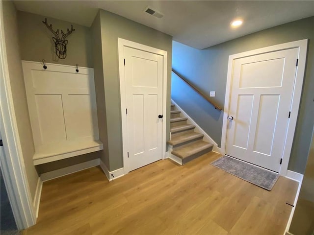 interior space with light wood-style floors, visible vents, and baseboards