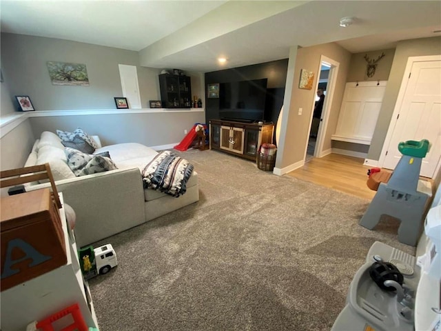 living room with light carpet and baseboards