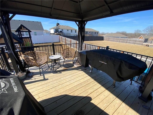 deck featuring a fenced backyard, a residential view, and a gazebo