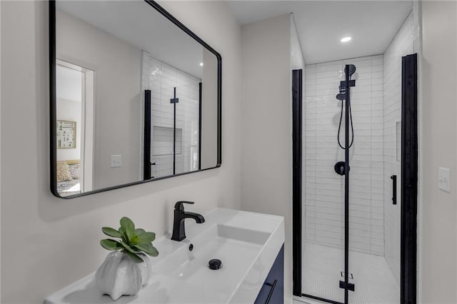 bathroom with a shower stall, vanity, and recessed lighting