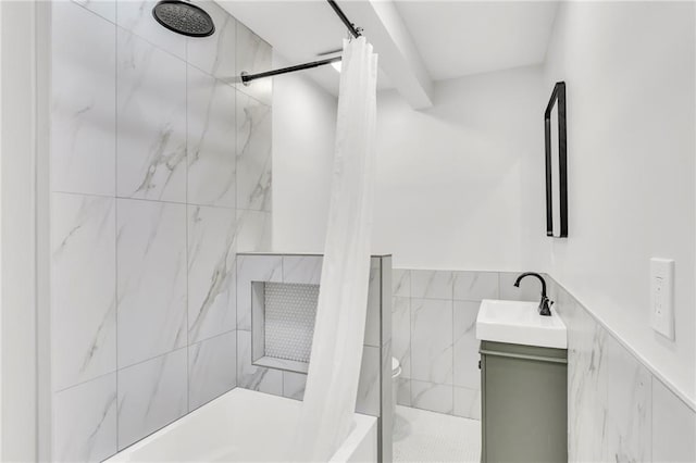 bathroom featuring wainscoting, vanity, tile walls, and a shower with curtain