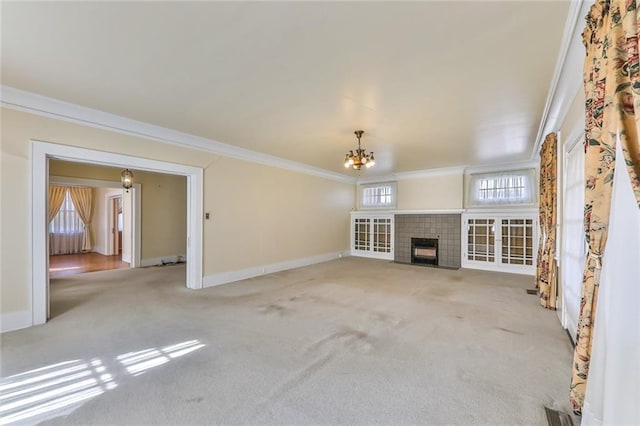 unfurnished living room featuring a chandelier, carpet flooring, crown molding, and baseboards