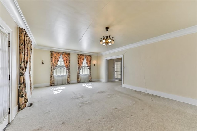 unfurnished room featuring an inviting chandelier, carpet, ornamental molding, and baseboards