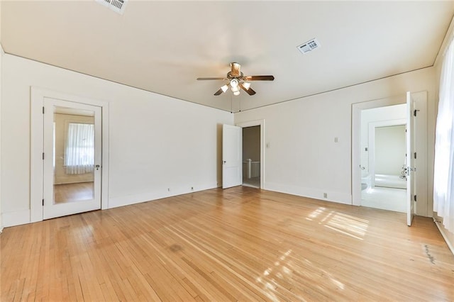 empty room featuring visible vents, ceiling fan, and light wood-style flooring