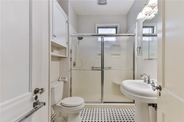 bathroom with toilet and a stall shower