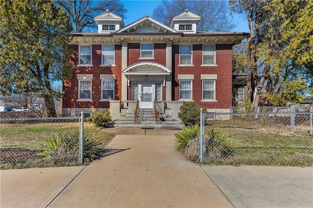 view of front facade with a fenced front yard, french doors, and brick siding