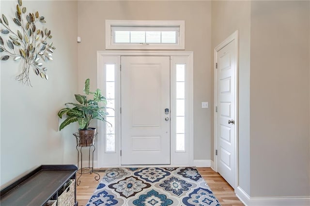 entrance foyer featuring light wood-style floors and baseboards