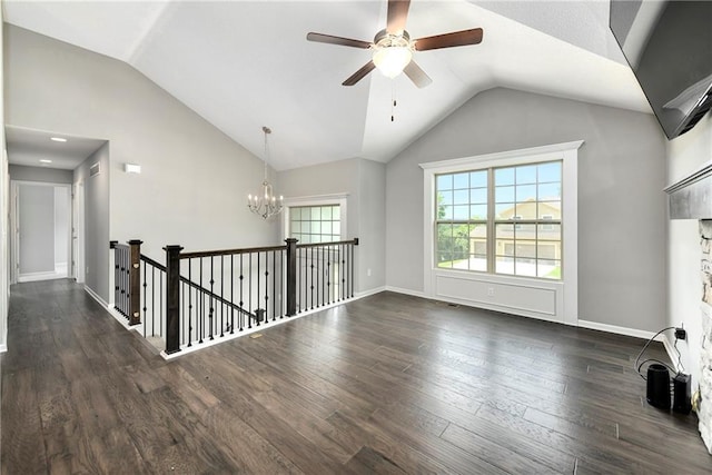 unfurnished room with lofted ceiling, dark wood-style flooring, baseboards, and ceiling fan with notable chandelier