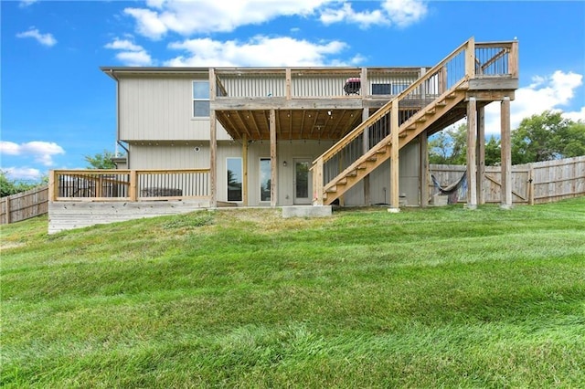 back of house with a deck, a yard, stairway, and fence