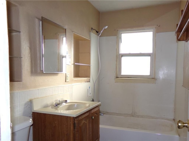 full bath featuring toilet, vanity, and bathing tub / shower combination