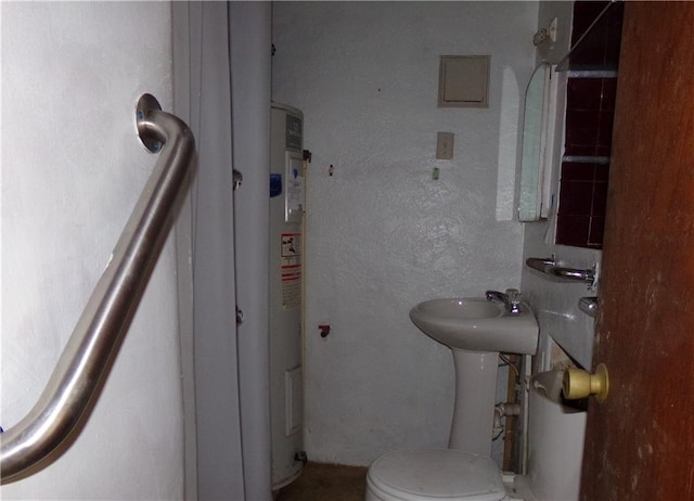 half bathroom with a textured wall and toilet