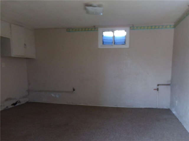 finished basement featuring dark colored carpet