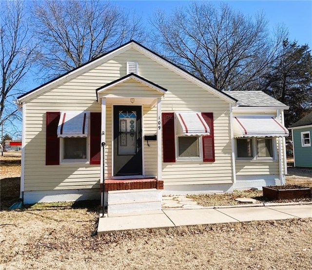 bungalow-style house with a shingled roof