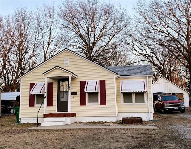 bungalow-style house with roof with shingles