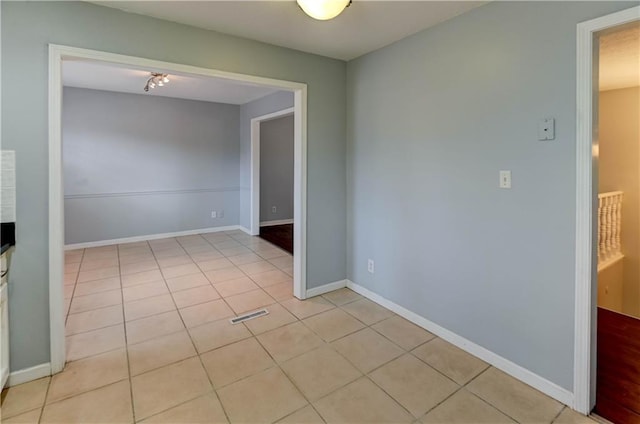 unfurnished room featuring visible vents, baseboards, and light tile patterned floors