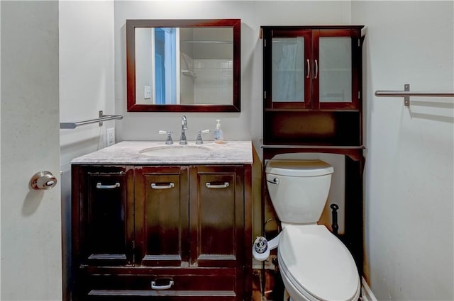 bathroom featuring toilet and vanity