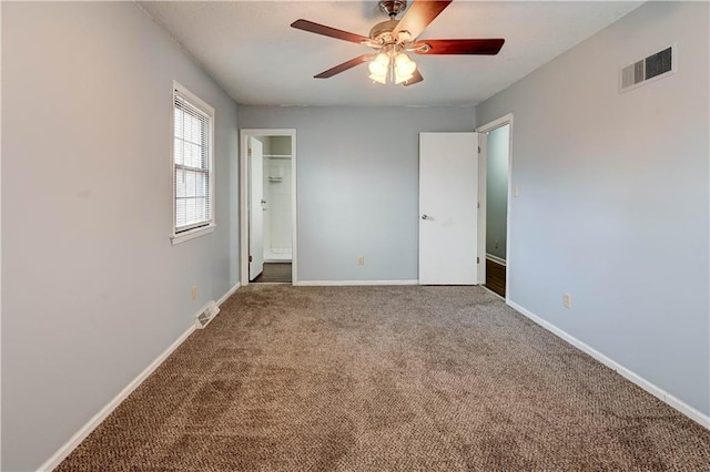 unfurnished bedroom with carpet floors, visible vents, baseboards, and a ceiling fan